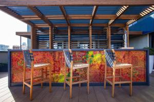 two chairs sitting next to a colorful wall at Hotel Paxton Barcelona in Barcelona