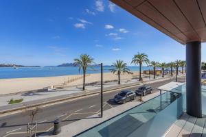 a view of the beach from the balcony of a building at Londres Derecha in Port de Pollensa