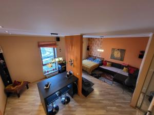 een woonkamer met een bank en een bed bij Solaris Studio Apartments in Rīga