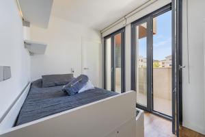 a bedroom with a bed and a large window at Londres Derecha in Port de Pollensa