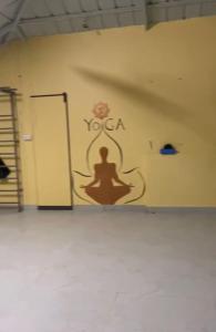 a room with a wall with a yoga mural on it at Homestay - Heaven Aumgarden in Trivandrum
