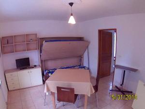 a room with a table and a bed and a desk at Residenza La Ruina in Fenestrelle