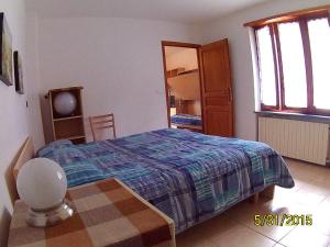 a bedroom with a bed and a table in it at Residenza La Ruina in Fenestrelle
