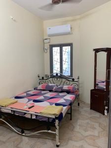 a bedroom with a bed in a room at VN GRAND RESIDENCY in Kottakupam
