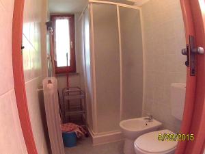 a bathroom with a toilet and a shower and a sink at Residenza La Ruina in Fenestrelle +14 photos