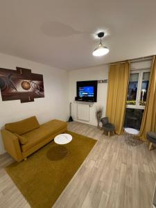a living room with a couch and a flat screen tv at Paris- Disney - Parking privé !PKN! in Torcy