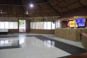 a large empty room with a bar in a building at Hotel Jungle Lunar in Sauraha