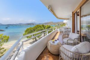 a balcony with chairs and a view of the ocean at El Faro in Port de Pollensa