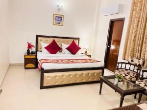 sypialnia z dużym łóżkiem z czerwonymi poduszkami w obiekcie Hotel Paras - Karol Bagh Delhi w Nowym Delhi
