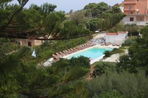 a swimming pool with lounge chairs and a resort at B&B Il Cavaliere Tropea in Santa Domenica