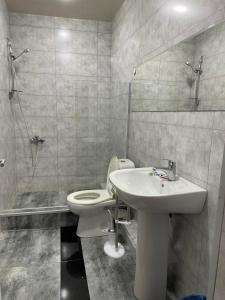 a bathroom with a toilet and a sink and a shower at Hotel ERA in Tbilisi City