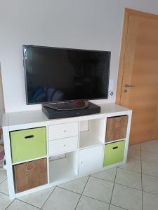 a white entertainment center with a flat screen tv on top at Elli's Moseloase - Riol in Riol