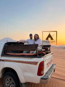 a man and a woman sitting in the back of a truck at Angelina Luxury Camp in Aqaba