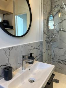 a bathroom with a sink and a mirror at Notre-Dame de Paris - Ile de la Cité in Paris