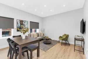a living room with a table and a couch at Stunning and Extremely spacious 1bed flat in Tooting in London