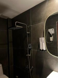 a bathroom with a shower with a mirror at Meow Hotel & Cafe 2 in Ho Chi Minh City