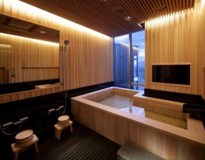 a large bathroom with a tub and a television at Terrazze in Niseko