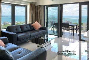a living room with a couch and a table at "PADSTOW" Top Location & Views at PenthousePads in Darwin
