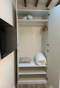 a walk in closet with white cabinets and a pillow at Notre-Dame de Paris - Ile de la Cité in Paris