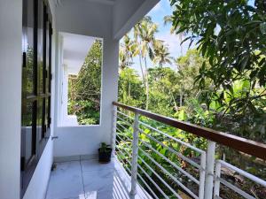 a balcony with a view of the forest at GOPURAM in Trivandrum