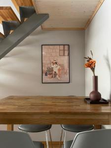 a dining room with a wooden table and chairs at Ristiku Guesthouse in Kuressaare