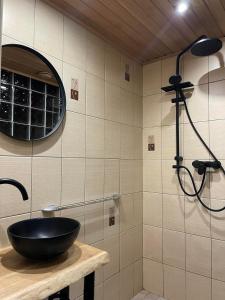a bathroom with a black sink and a shower at Ristiku Guesthouse in Kuressaare