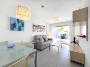 a living room with a table and a couch at Apartamentos Hipocampos Calpe Rent Apart in Calpe
