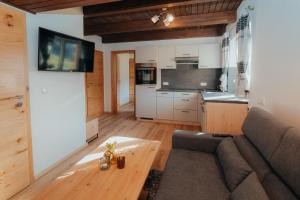 a living room with a couch and a table at Bergblickapartments in Spital am Pyhrn