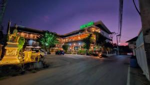 a building with a sign on top of it at night at Must Come Boutique Hotel in Ban Nam Khong
