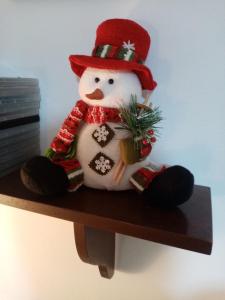 a snowman sitting on top of a shelf at La tana delle coccinelle in Capracotta