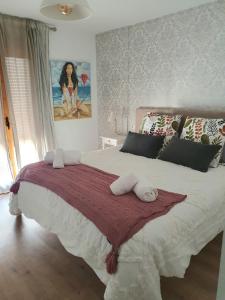 a bedroom with a large bed with pillows on it at EL ÚNICO apartment with jacuzzi and art in Guadalest