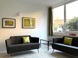 a living room with two couches and a table at Apartments Navigli in Milan