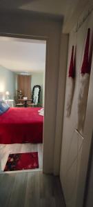 a bedroom with a red bed and a dining room at La Casa della Rosa Nana in Trezzano sul Naviglio +13 photos
