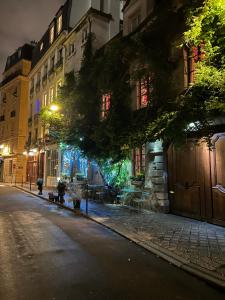 an empty street at night with buildings and lights at Notre-Dame de Paris - Ile de la Cité in Paris