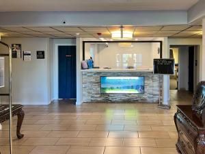 a lobby with a fireplace with a tv in it at Studio 6 Suites Springfield, OH in Springfield