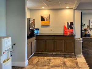 a waiting area in a office with a counter at Studio 6 Suites Springfield, OH in Springfield