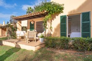 una terraza de madera con 2 sillas y una pérgola en Menorca Paradise nº 30 en Son Xoriguer