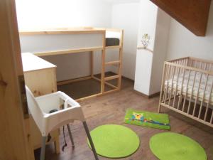 a small room with a bunk bed and a crib at Reitanlage Duffner in Horst