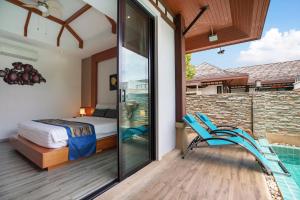 a bedroom with a bed and a balcony with a pool at Cozy 2Br Pool Villa Lexi*200m to Rawai Beach*Kids Park in Rawai Beach