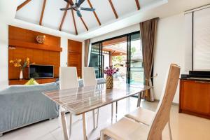 a dining room and living room with a table and chairs at Cozy 2Br Pool Villa Lexi*200m to Rawai Beach*Kids Park in Rawai Beach