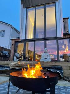 a fire pit with a snowman in front of a house at 3BR Gem, 8 Min Drive to Bicester Village in Bicester