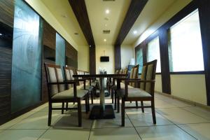a dining room with a table and chairs at Dvr Mansion in Kurnool