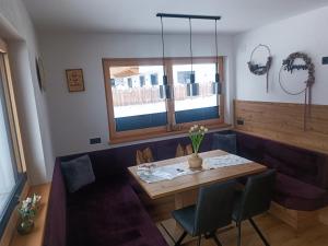 a dining room with a wooden table and chairs at Alpenoase Horbergbahn in Schwendau +46 photos