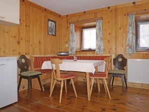 a dining room with a table and four chairs at Holiday Home Haus Helena by Interhome in Längenfeld