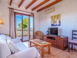 A television and/or entertainment centre at Apartment Finca Can Corritx-1 by Interhome