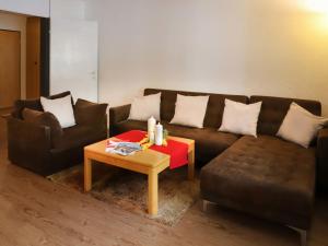 a living room with a couch and a table with candles at Apartment Allod-Park-5 by Interhome in Davos