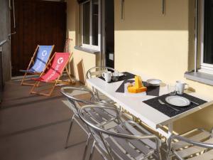 a table and chairs in a room with signs at Apartment Allod-Park-57 by Interhome in Davos