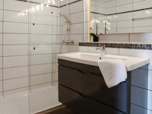 a bathroom with a sink and a mirror at Apartment Allod-Park-53 by Interhome in Davos