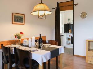 a dining room table with a white table cloth and a lamp at Apartment Allod Park Haus C 605 by Interhome in Davos +42 photos