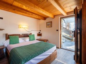 a bedroom with a bed and a large window at Studio Ancienne Bergerie Studio 1 - VOU140 by Interhome in Valtournenche